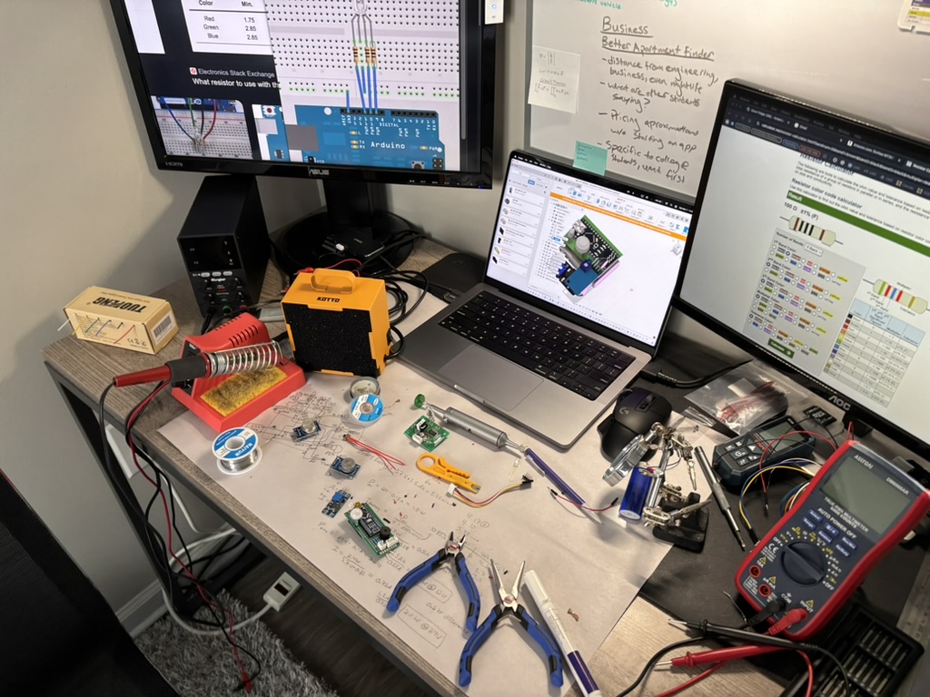 Workbench with soldering iron, multimeter, monitors and a breadboard used to build the BlazeBlock prototype