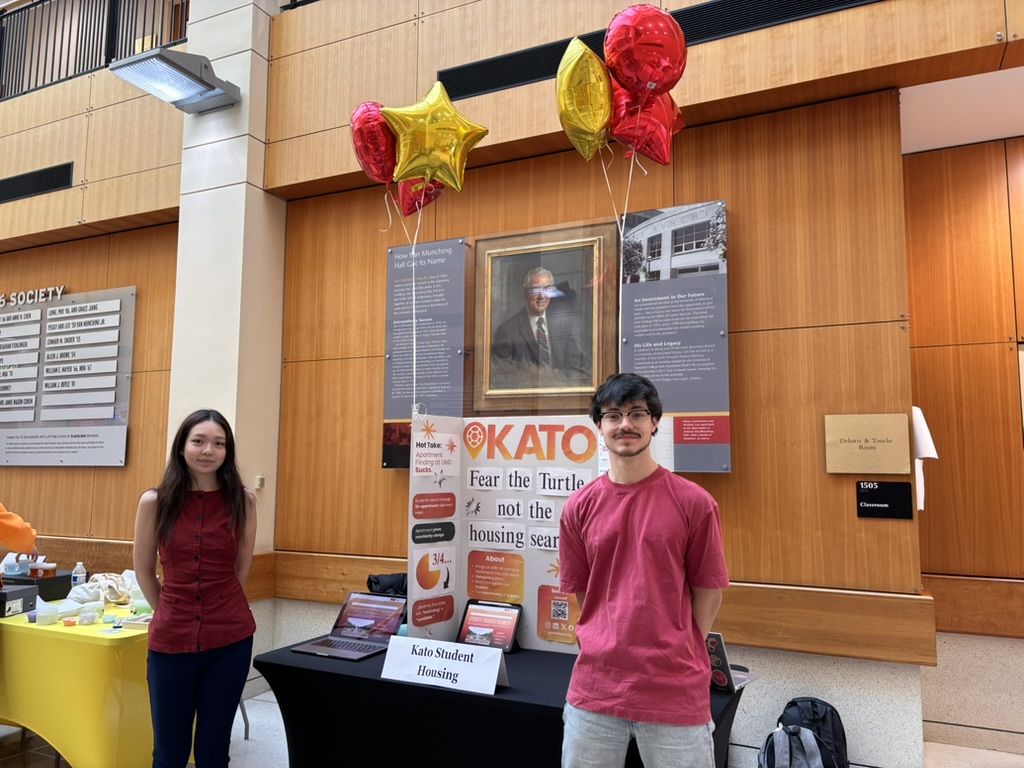 Adam Pouliot and a teammate at the Kato Student Housing booth